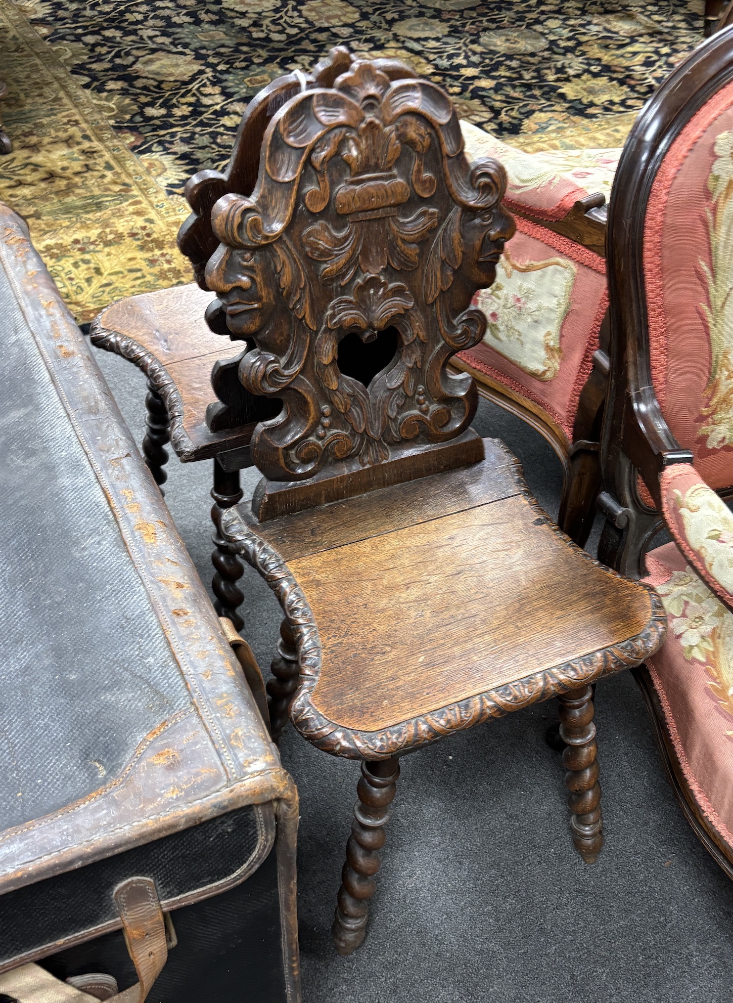 A pair of 19th century Flemish carved oak hall chairs, width 42cm, depth 36cm, height 88cm